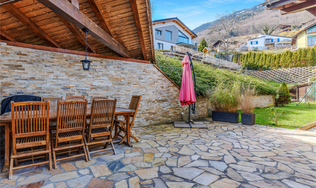 patio / terrace with outdoor dining space, a patio, and a mountain view