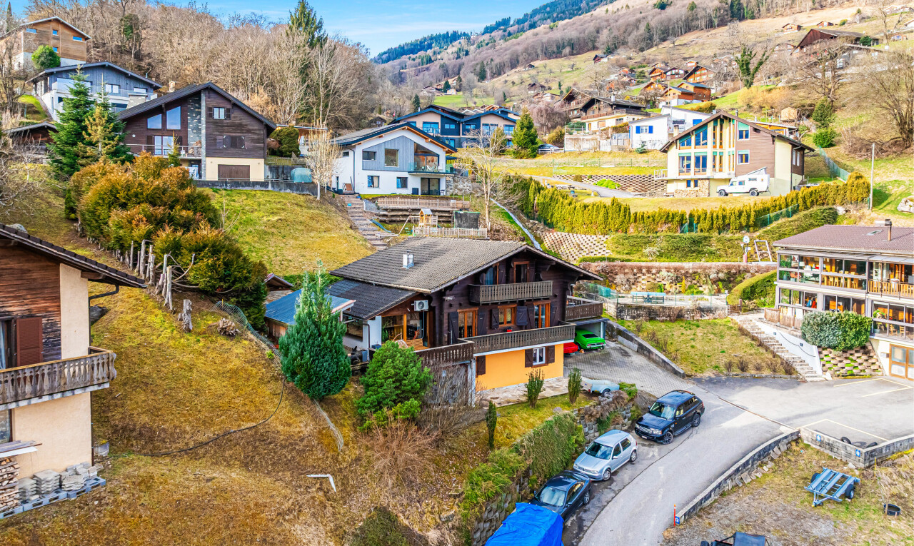 view of property featuring a balcony, a mountain view, and a residential view