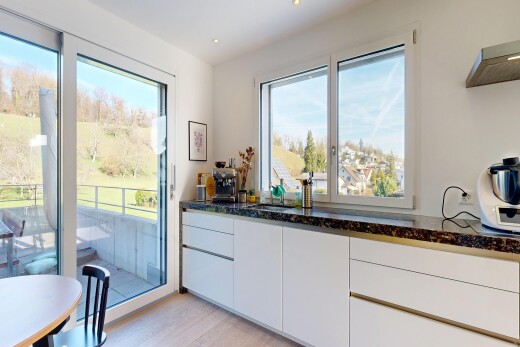 kitchen with dark stone countertops, light wood-style flooring, white cabinetry, and modern cabinets