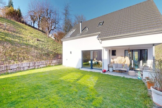 view of property with a lawn, stucco siding, a patio, and an outdoor living space