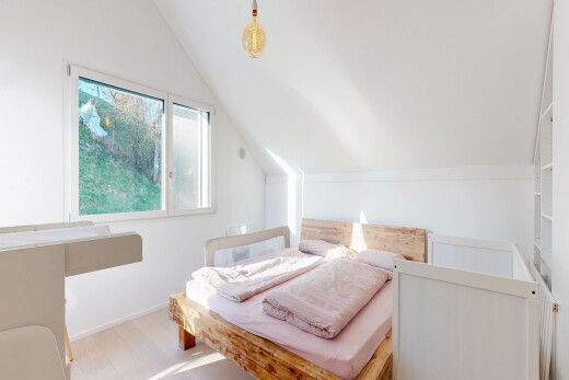 room / bedroom featuring vaulted ceiling and light wood-style flooring