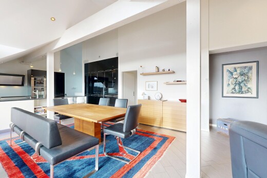dining space with a towering ceiling and light wood-type flooring