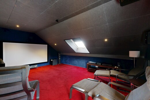 carpeted living room featuring a skylight and lofted ceiling