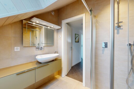 full bath with vanity, tile walls, a stall shower, and light tile patterned floors