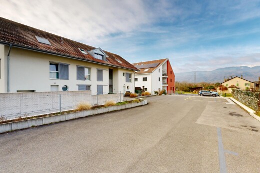 outdoor house featuring stucco siding, a residential view, and uncovered parking
