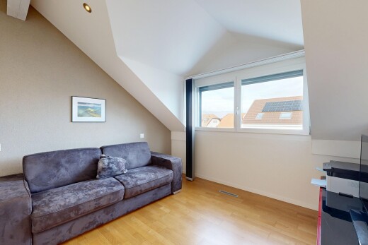 living room with light wood-type flooring and vaulted ceiling