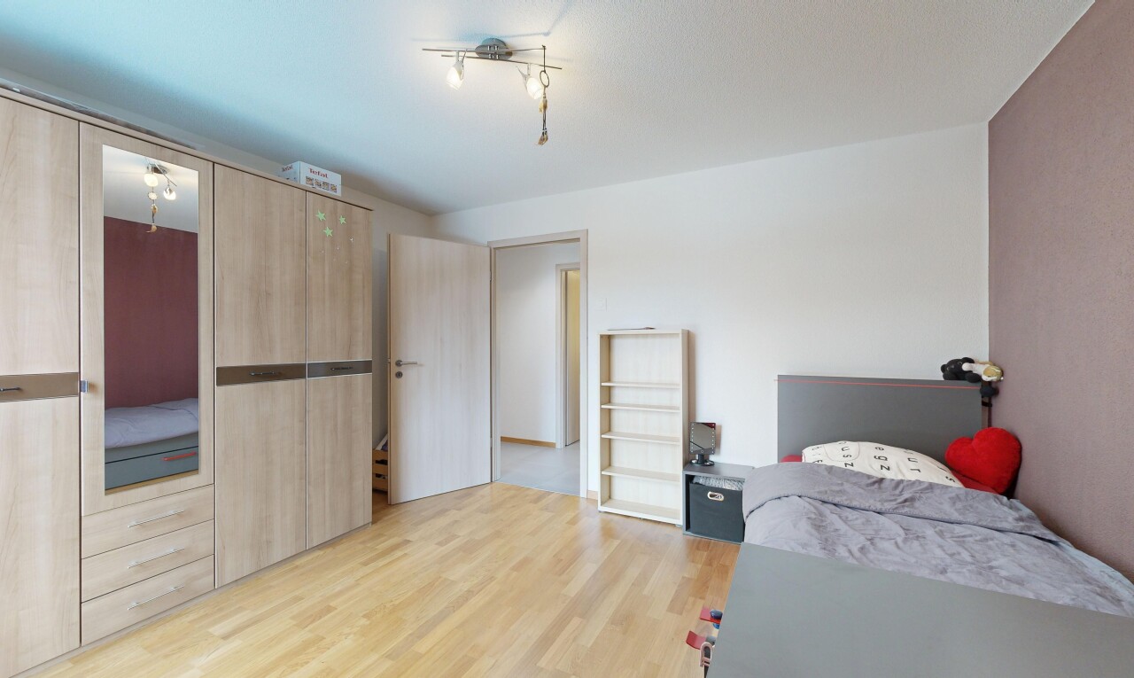 room with light wood finished floors and a closet
