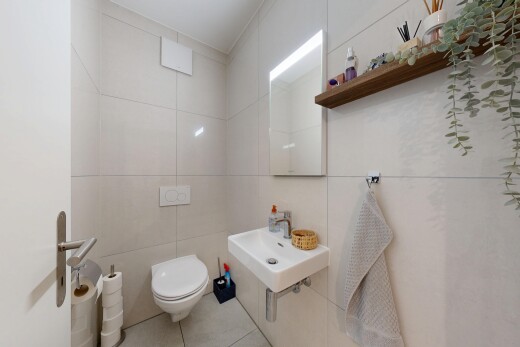 salle de bains avec miroir, tile wall, mur en carrelage, toilette, et inside property
