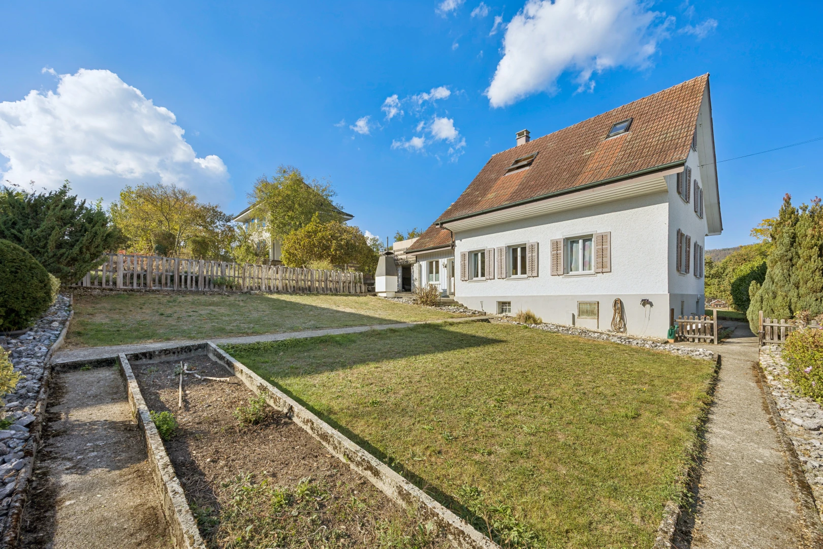 outdoor house featuring a garden