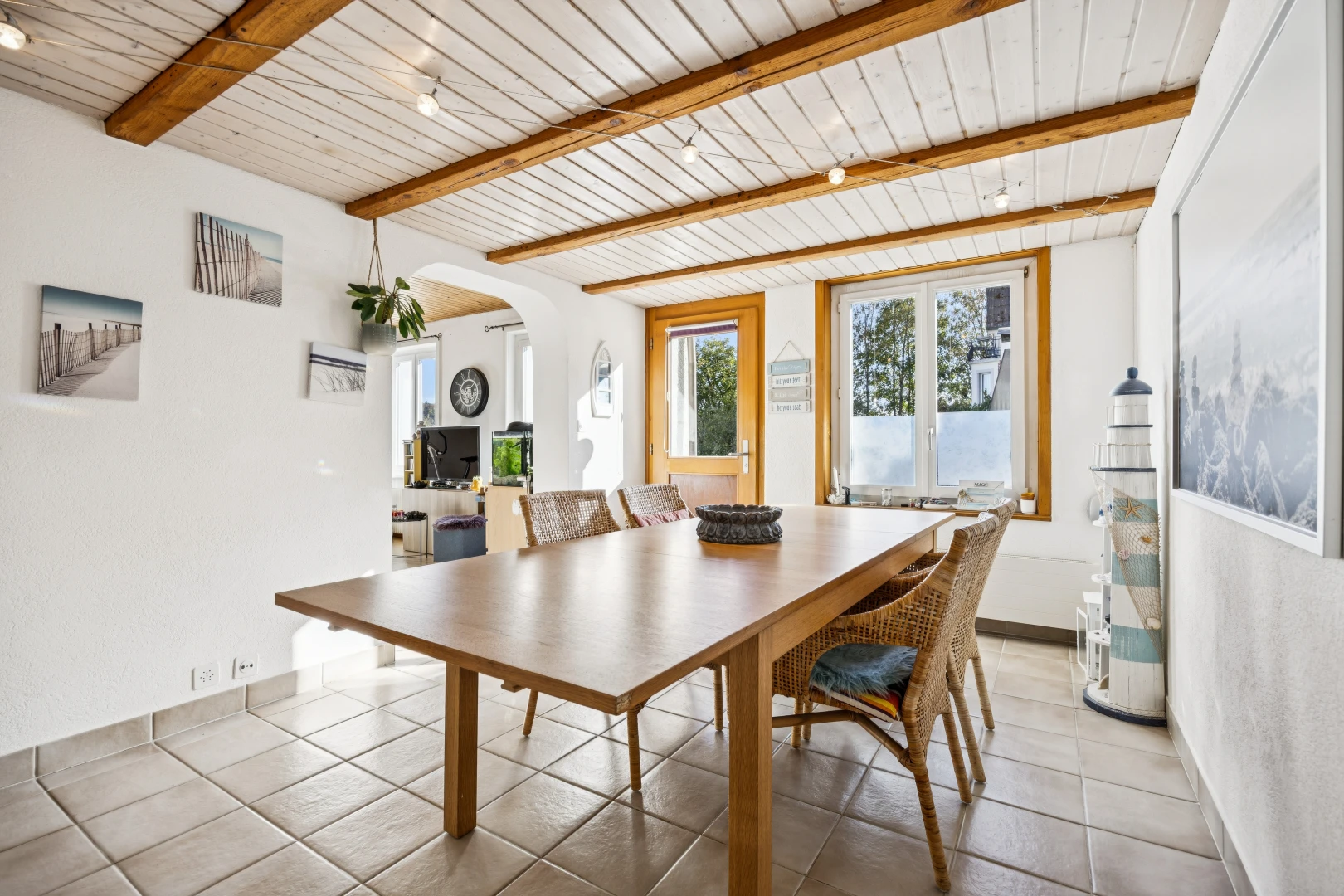 dining room with arched walkways, access to exterior, a wood ceiling with exposed beams, and light tile patterned floors