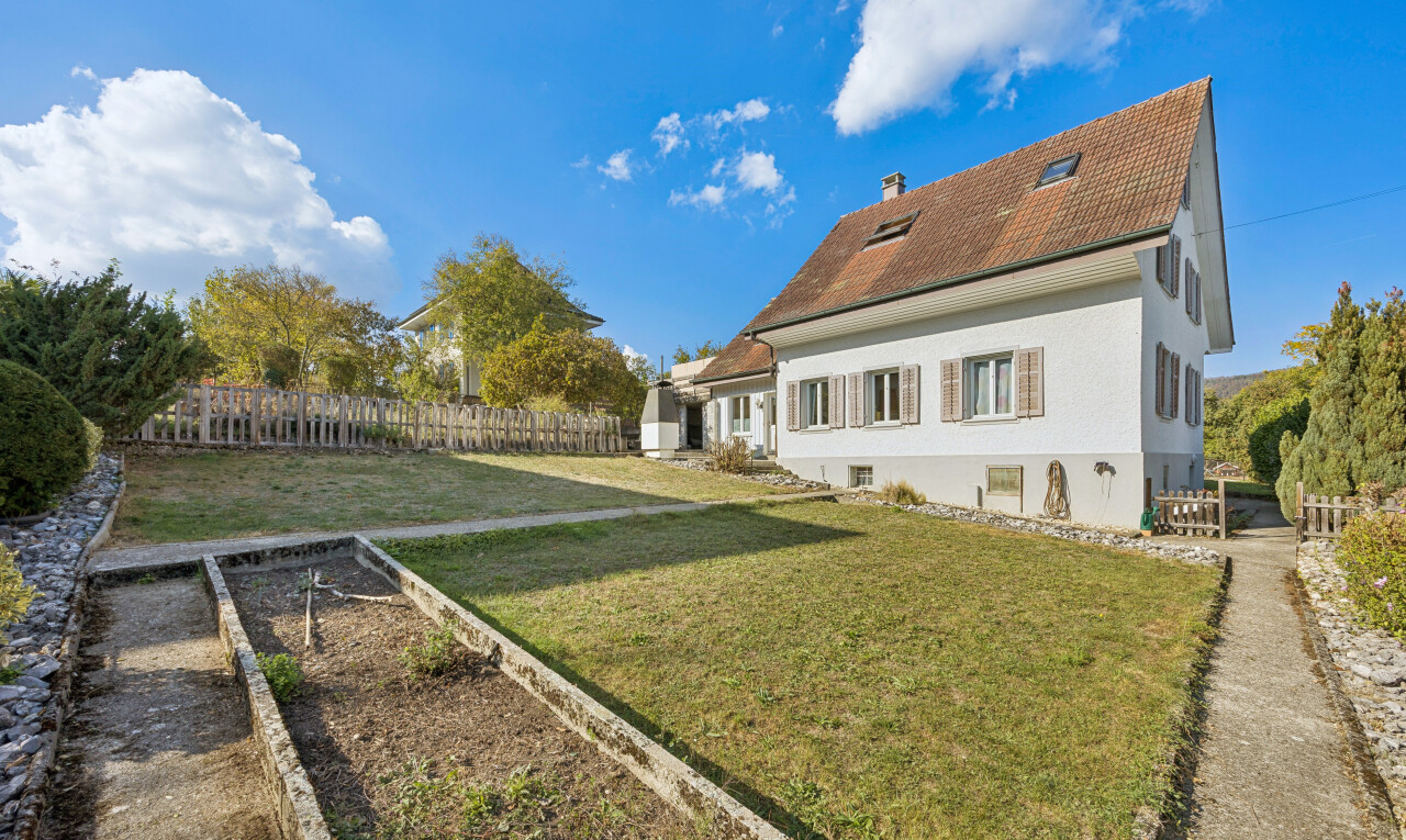 outdoor house featuring a garden