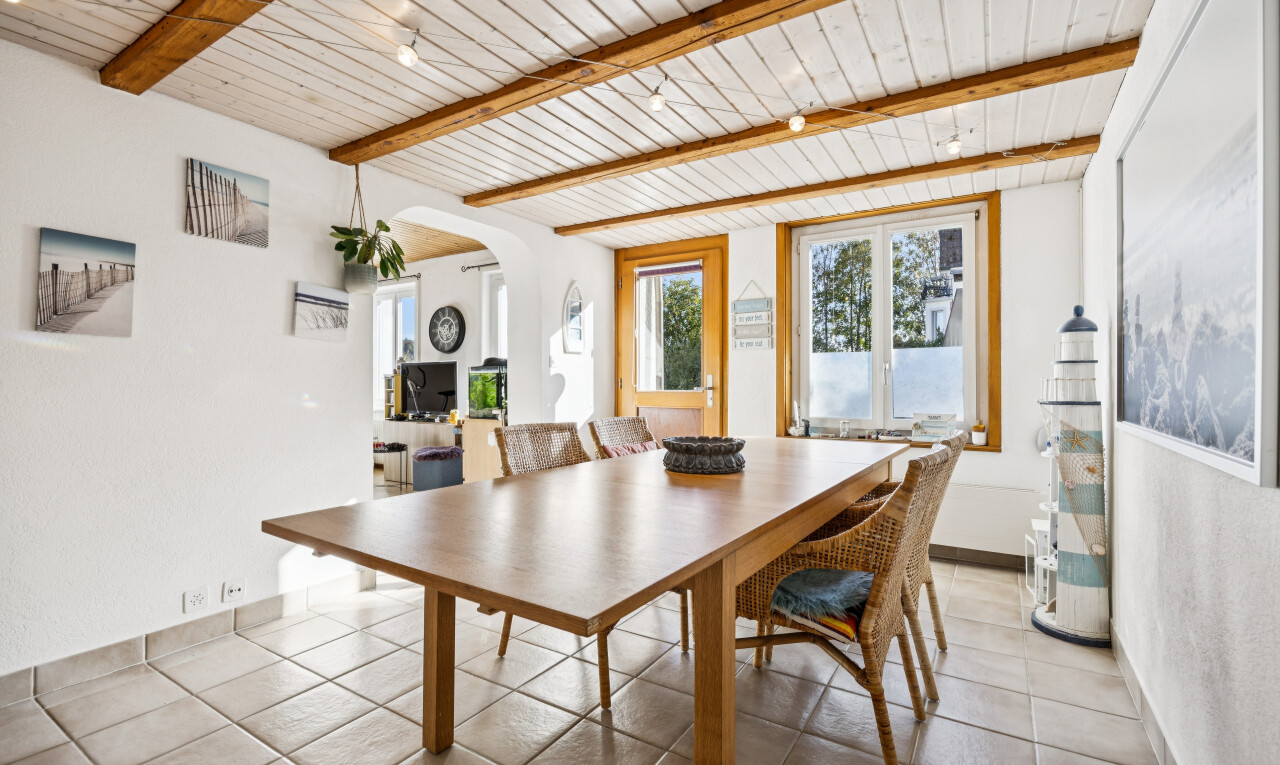 dining room with arched walkways, access to exterior, a wood ceiling with exposed beams, and light tile patterned floors