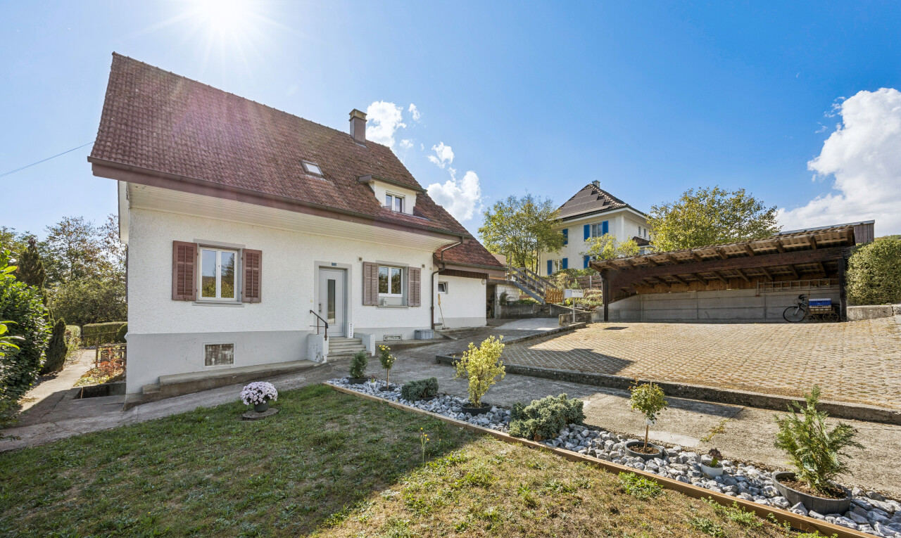 view of home with a chimney and a lawn