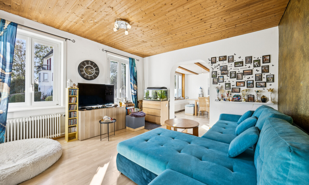 living room featuring radiator, wood ceiling, arched walkways, and light wood-style flooring