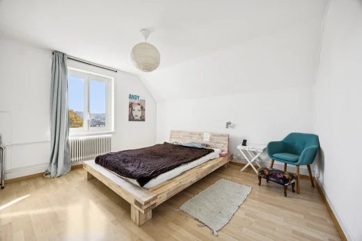 room featuring radiator heating unit, lofted ceiling, and light wood-style flooring