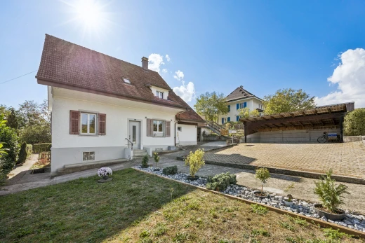 view of home with a chimney and a lawn