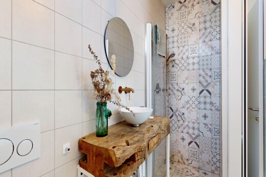 full bath featuring tile walls, a shower stall, and vanity