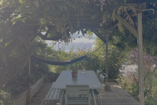 exterior space featuring a wooden deck and outdoor dining area