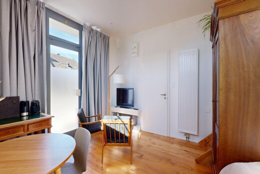living / dining room featuring radiator and light wood-type flooring