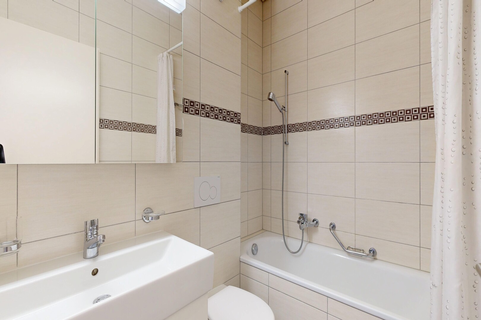 full bath with tile walls, tiled shower / bath, and vanity