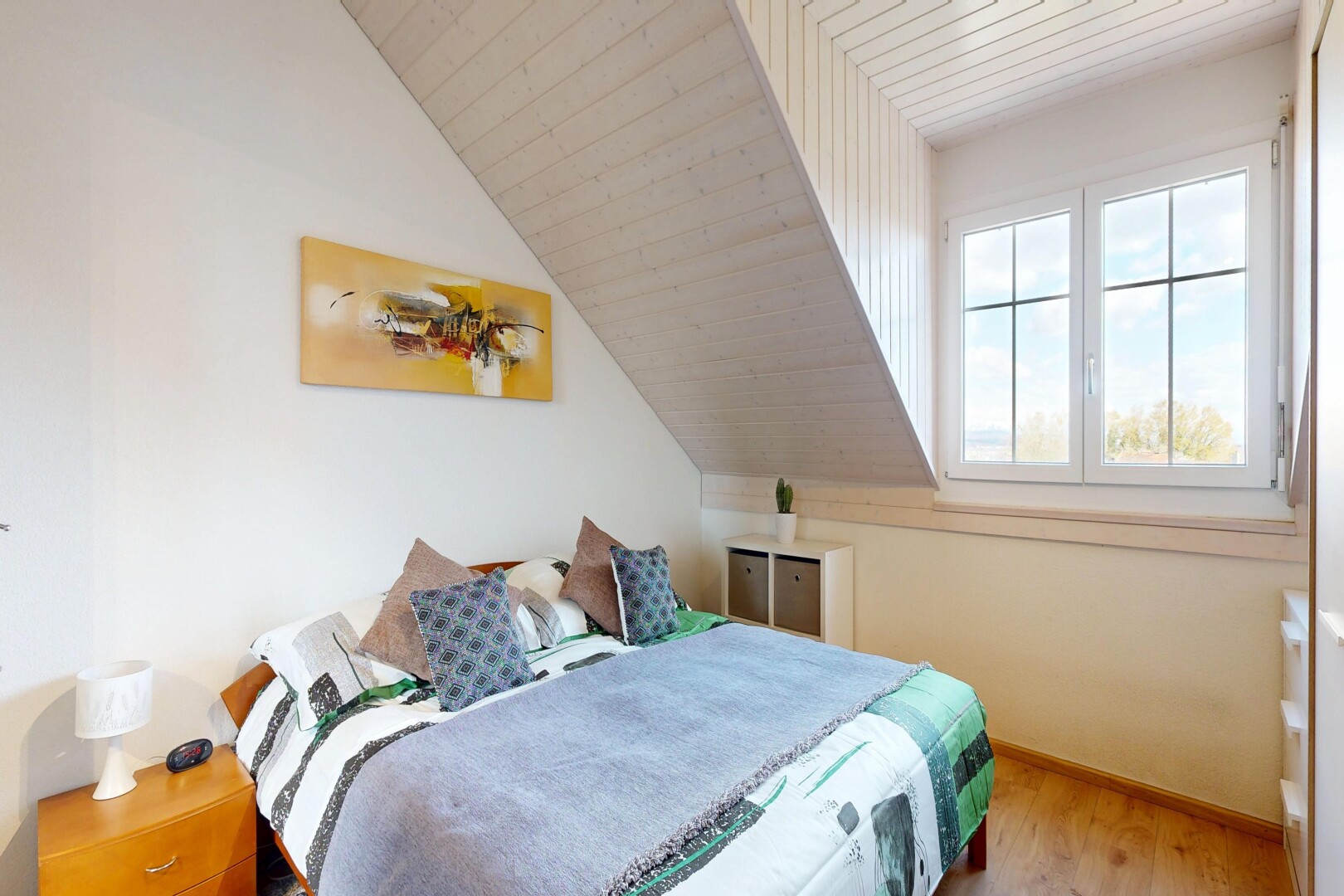 room with a vaulted wooden ceiling and light wood-style floors