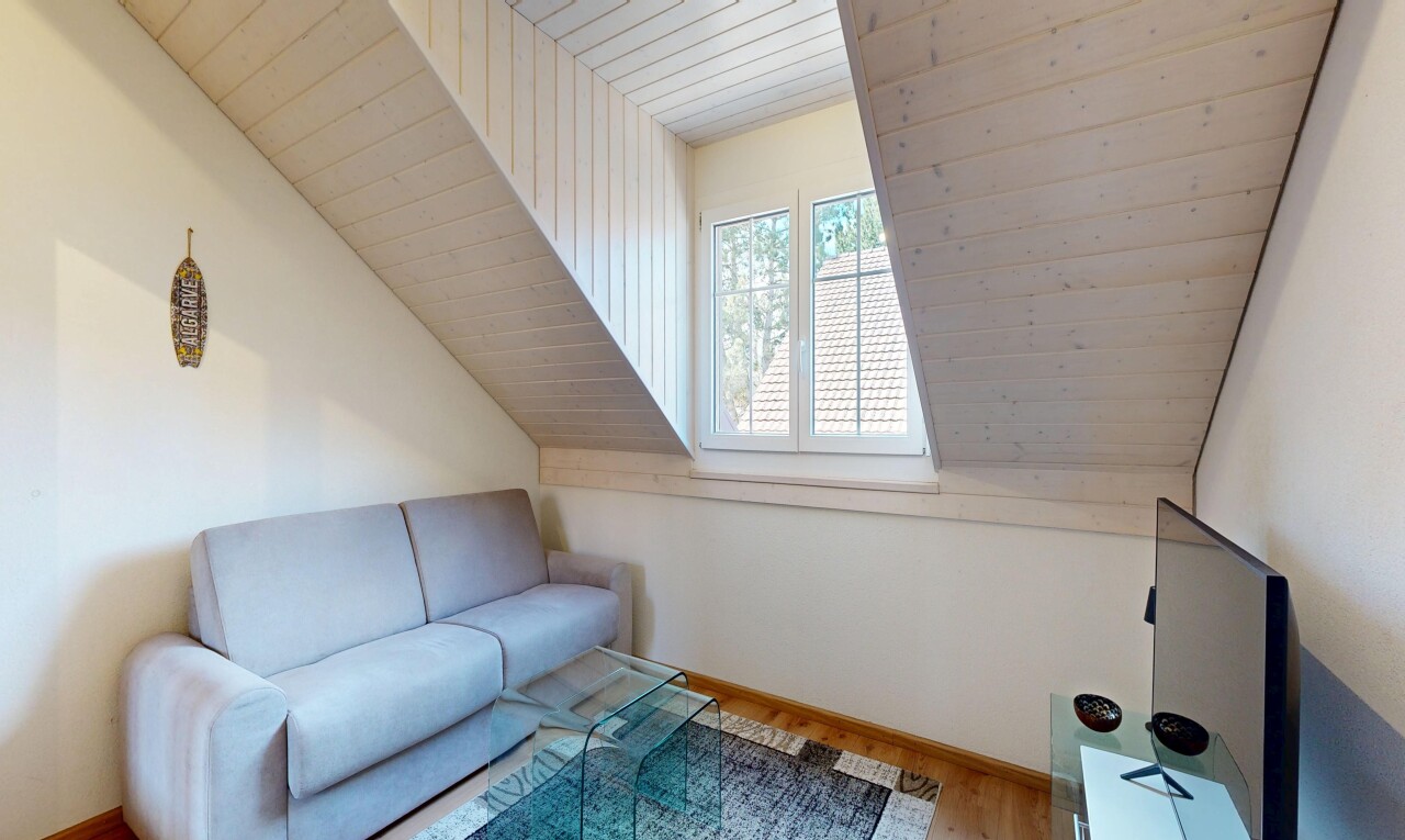 living area featuring a vaulted wood ceiling and wood finished floors