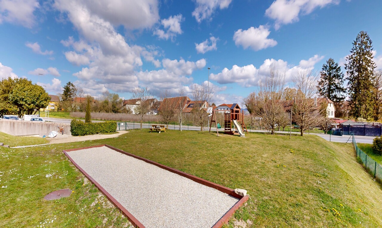 garden featuring a lawn and a game area