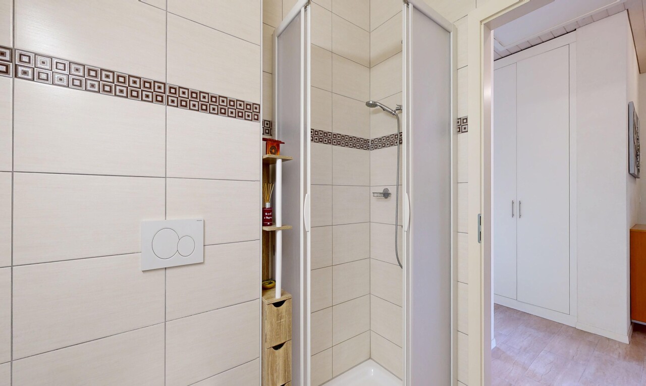 bathroom featuring a shower stall and light wood finished floors