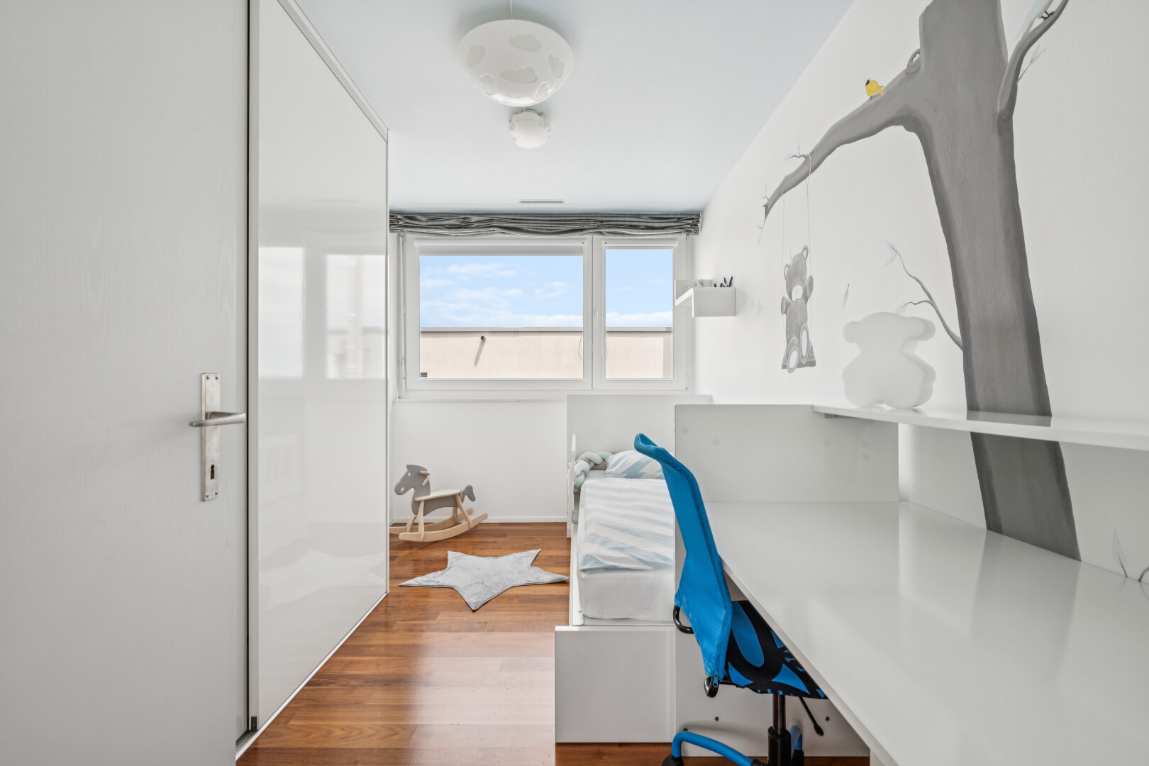 office with wood finished floors and built in study area