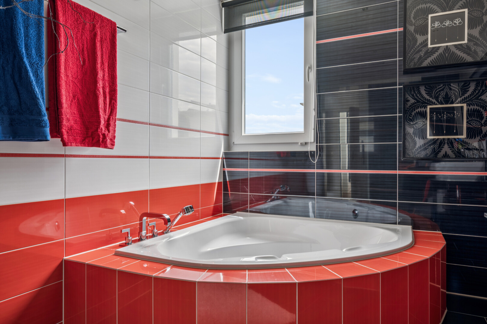bathroom featuring tile walls, tiled tub, and a shower