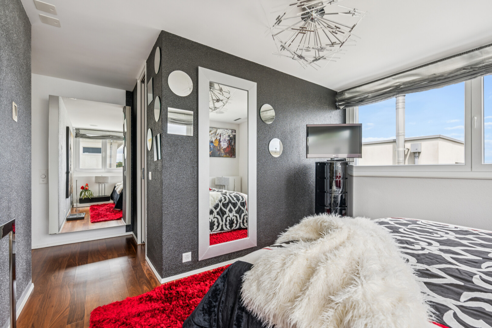 room / bedroom featuring dark wood finished floors and hanging lights