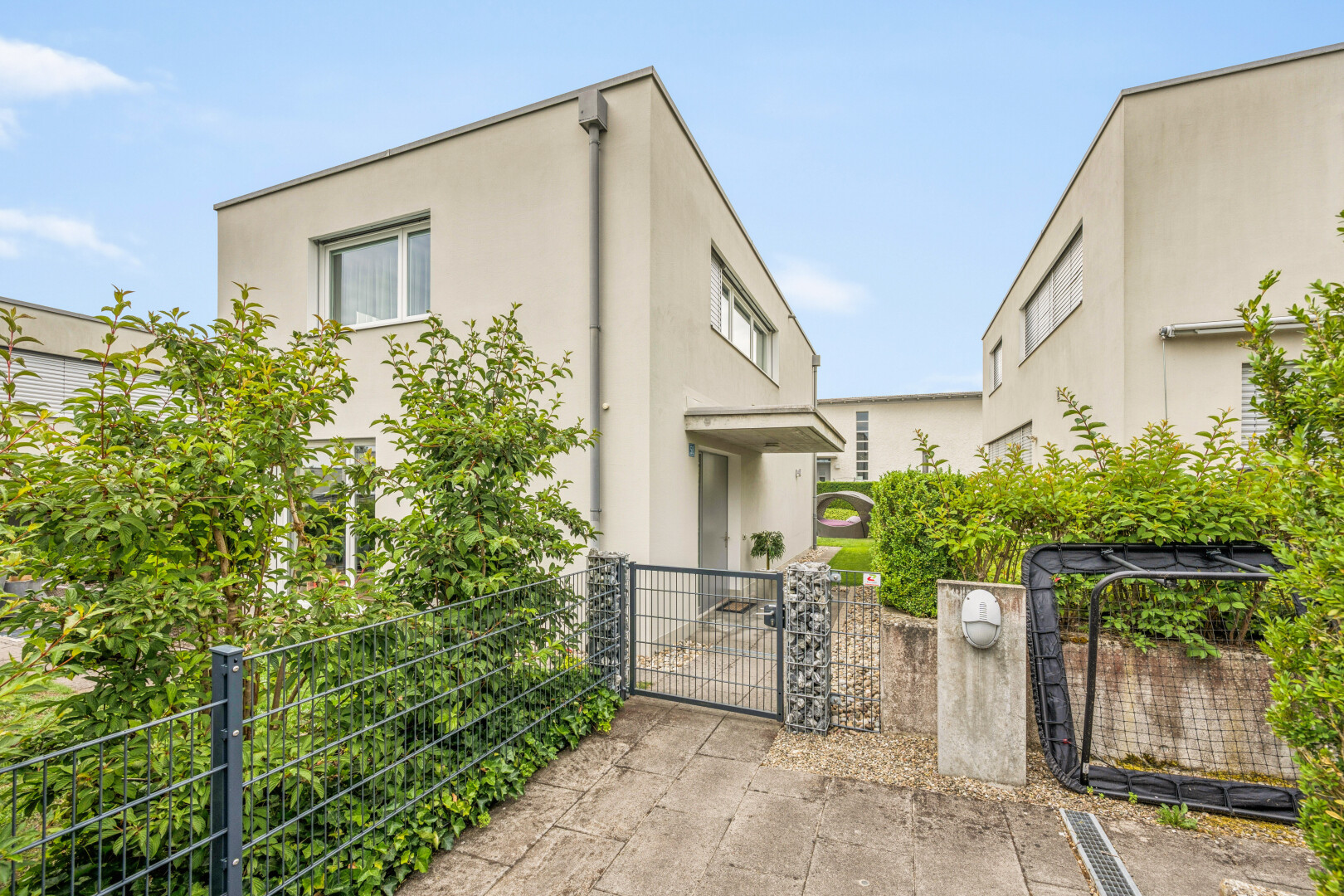 outdoor house featuring a gate, a fenced front yard, and stucco siding