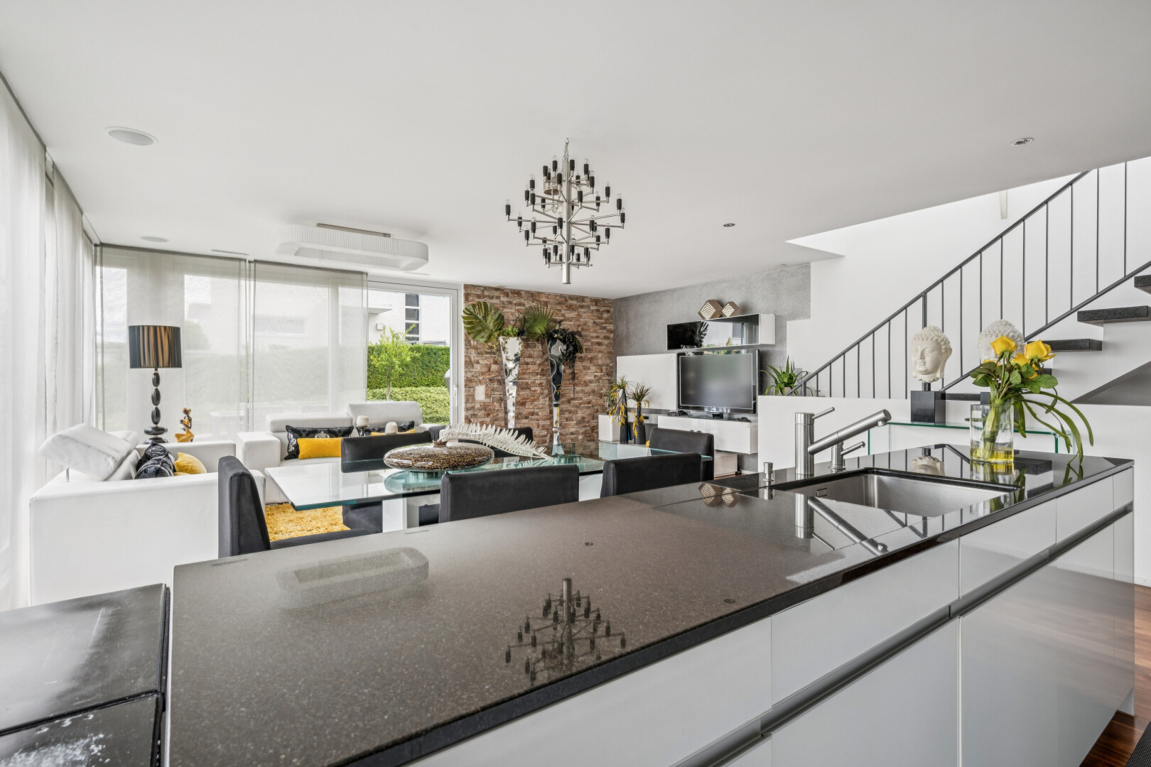kitchen featuring open floor plan, modern cabinets, white cabinets, dark stone counters, and dark wood-style flooring