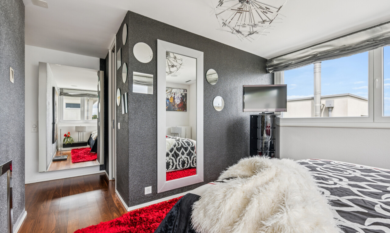 room / bedroom featuring dark wood finished floors and hanging lights