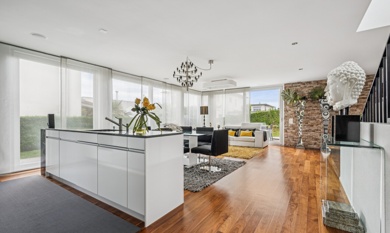 kitchen with an island with sink, dark wood finished floors, open floor plan, modern cabinets, and white cabinets