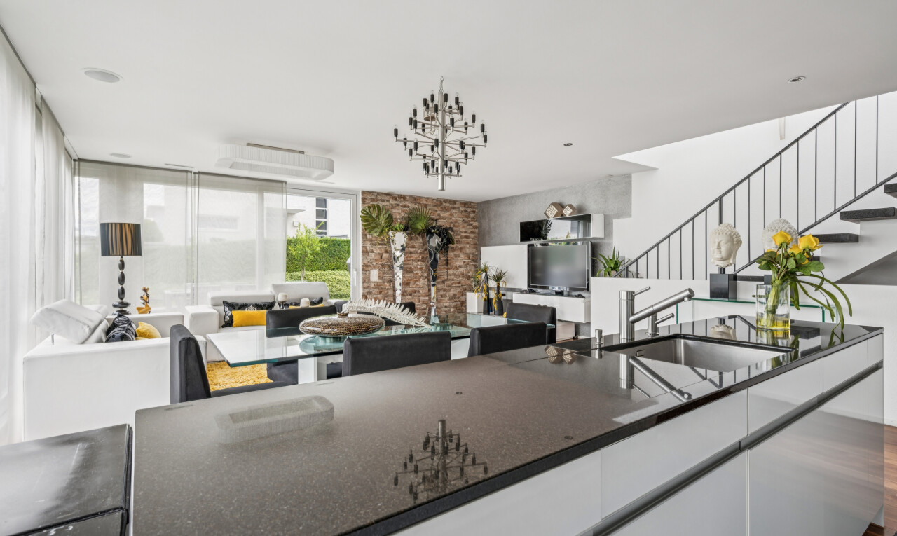 kitchen featuring open floor plan, modern cabinets, white cabinets, dark stone counters, and dark wood-style flooring