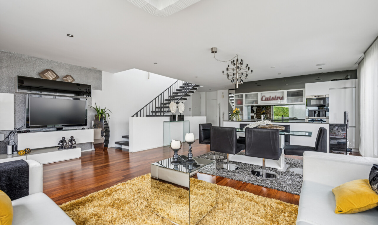 living area featuring wood finished floors and stairs