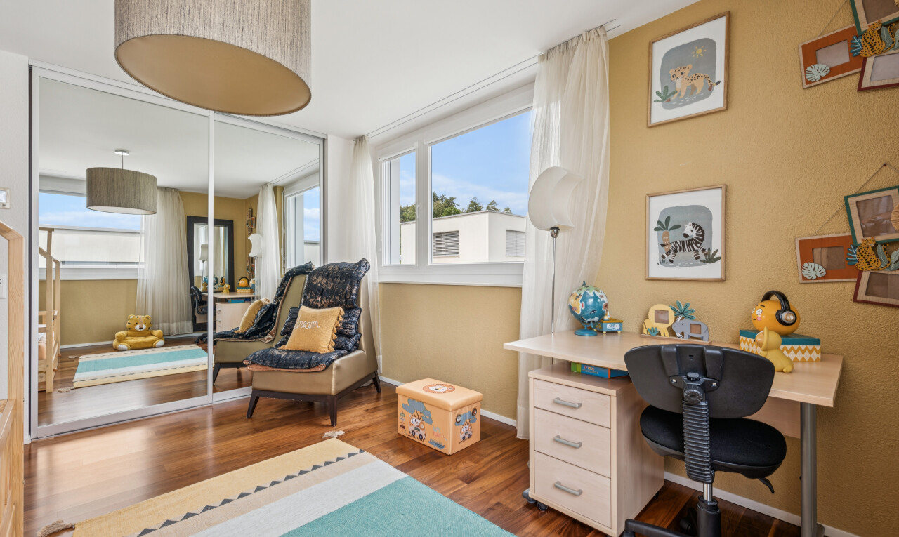 room with dark wood-style flooring, an office area, and a closet