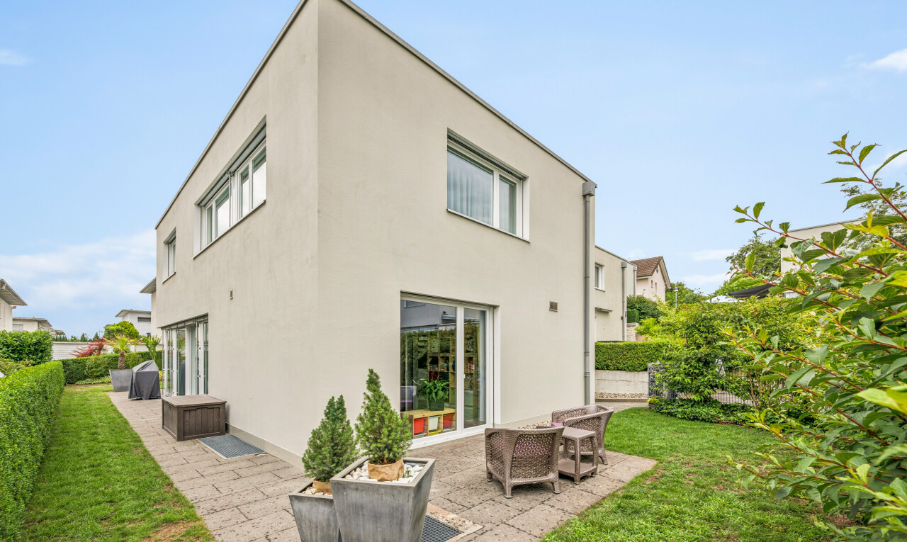 view of home featuring a patio area, a lawn, and stucco siding
