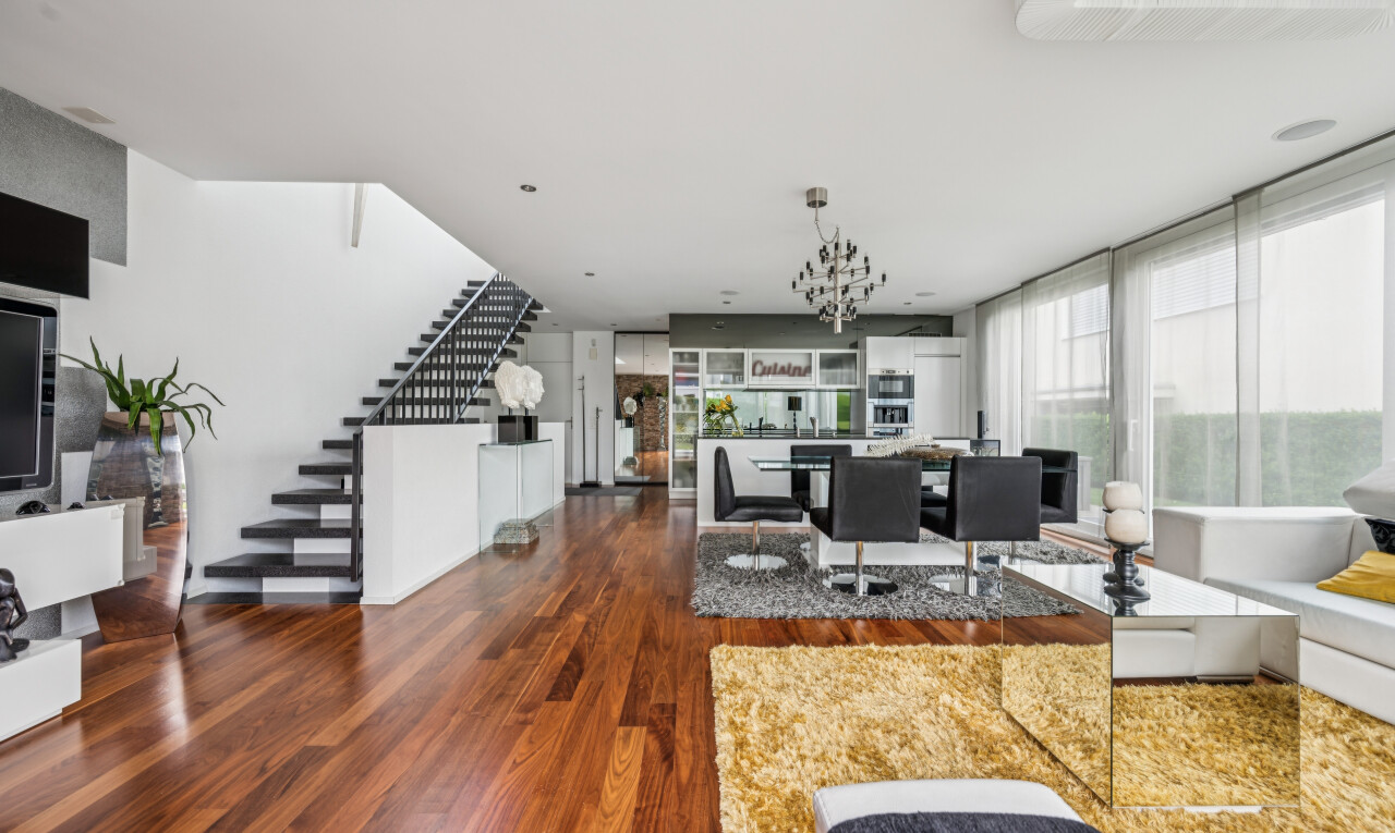 living / dining area with dark wood-type flooring and suspended lighting