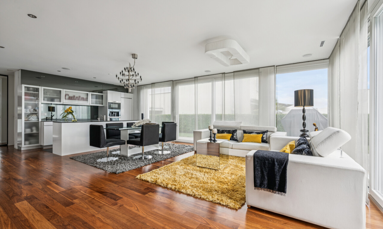living room featuring dark wood-style flooring and suspended lighting