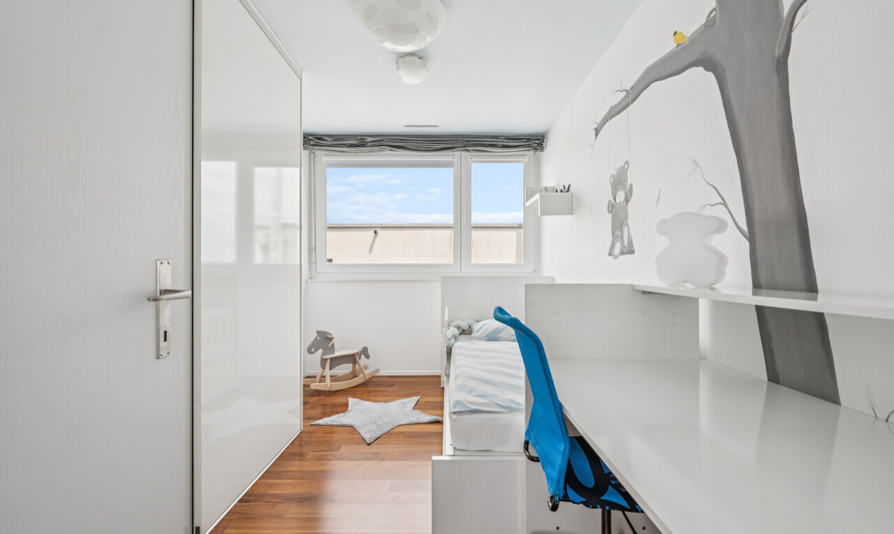 office with wood finished floors and built in study area
