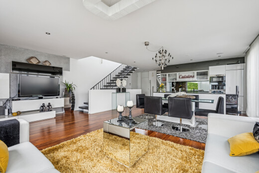 living area featuring wood finished floors and stairs