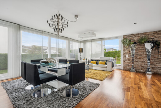 living room featuring light wood-type flooring and expansive windows