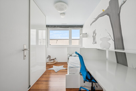 office with wood finished floors and built in study area