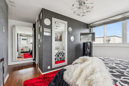 room / bedroom featuring dark wood finished floors and hanging lights