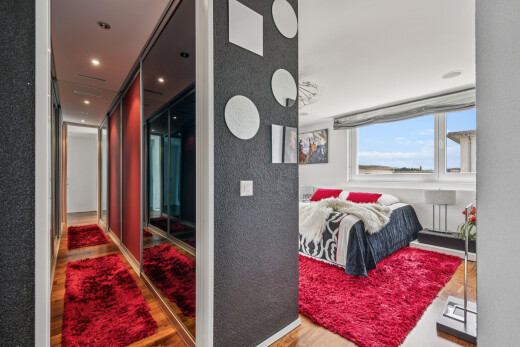room featuring light wood finished floors, a textured wall, a closet, and recessed lighting