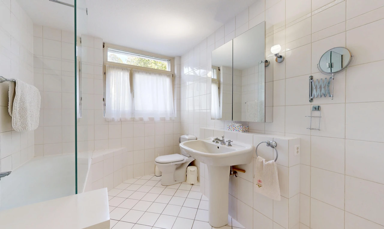 salle de bains avec mur en carrelage, tile wall, salle de bain complète, miroir, et toilette