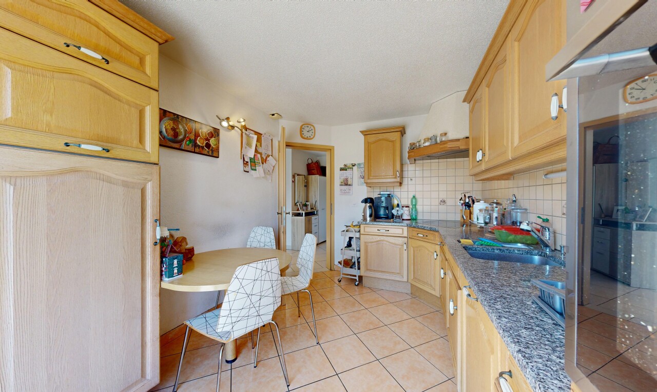 cuisine avec armoires en arc, arched cabinets, armoires marron clair, light brown cabinets, et backsplash