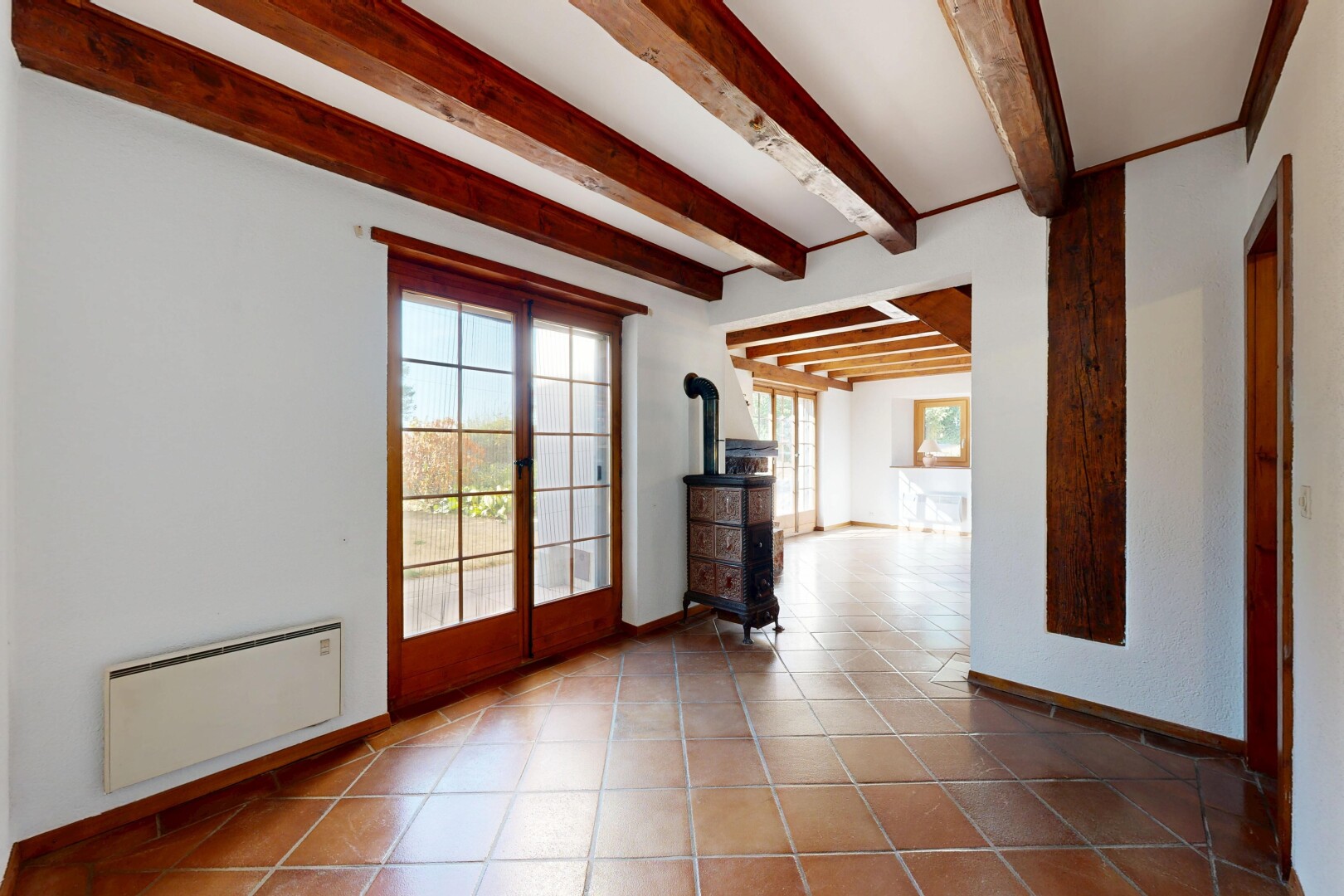 leerer raum mit beamed ceiling, balkendecke, holzofen, high end ceiling, und drywall